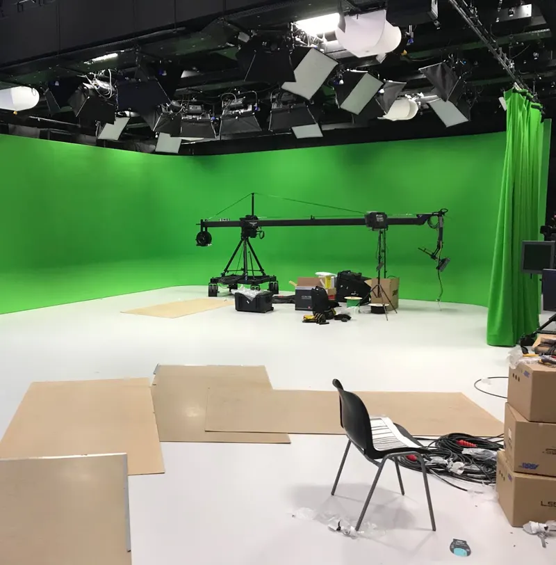 Al Araby TV's green-screen Studio 2 at Park Royal during the build, with a camera jib being assembled under the lighting grid.